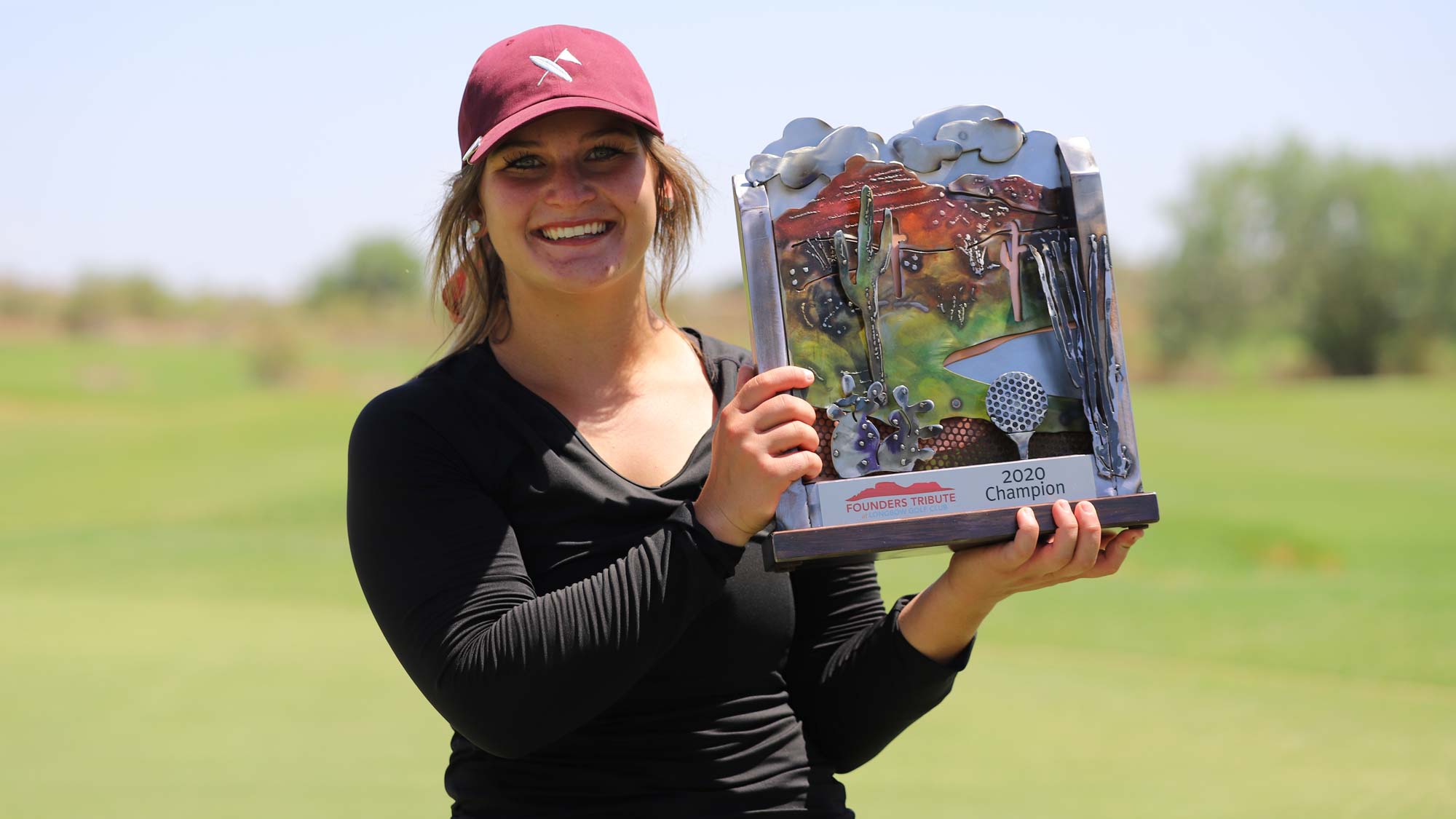 Sarah White holds the Founders Tribute trophy