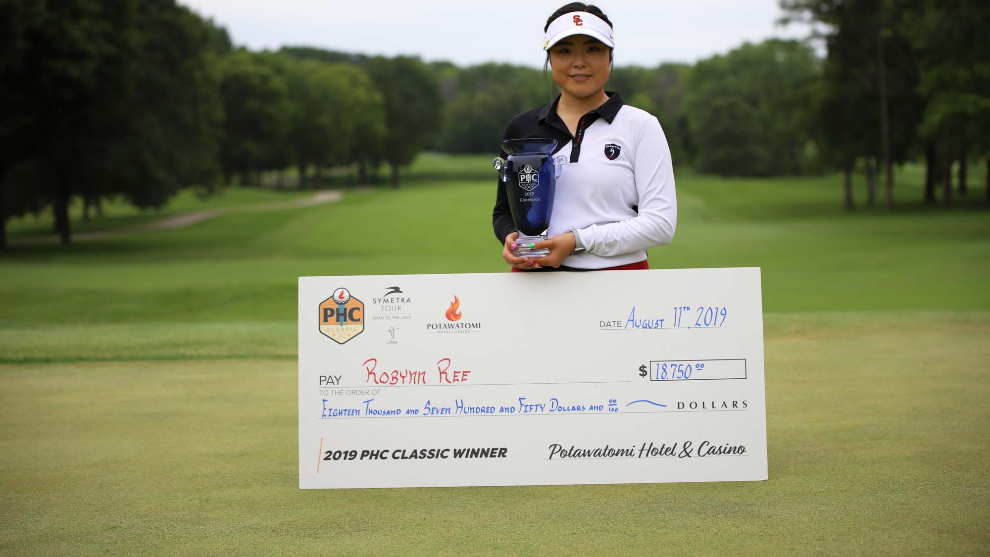 Robynn Ree with trophy and check